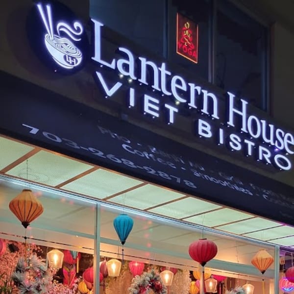 Exterior of Lantern House Viet Bistro with a glowing sign and colorful lanterns in the window.